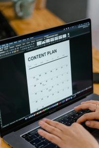 Person planning AI marketing content on a laptop